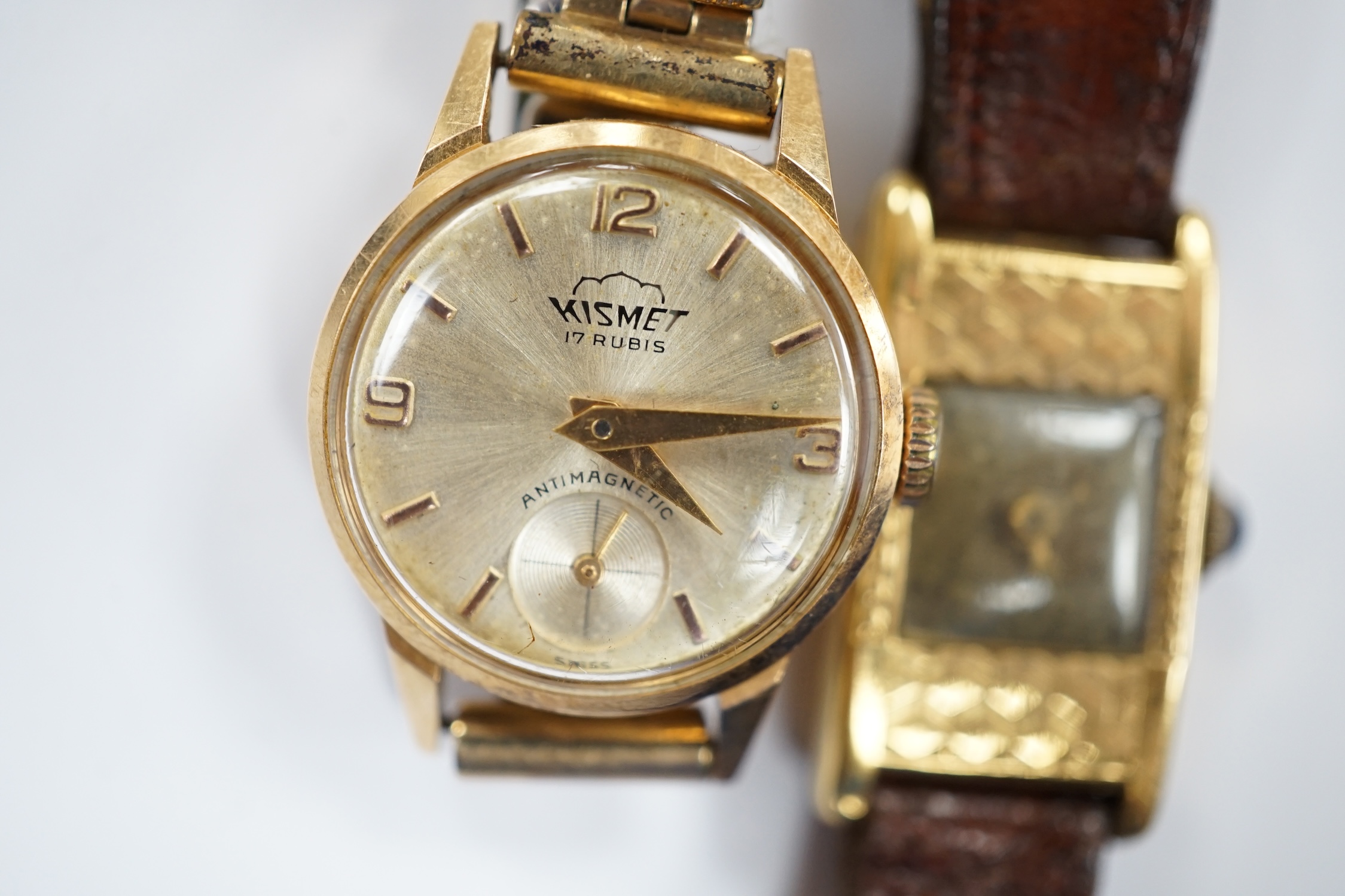 Two 18k cased lady's manual wind wrist watches, including Kismet, on gold plated or leather bracelets.